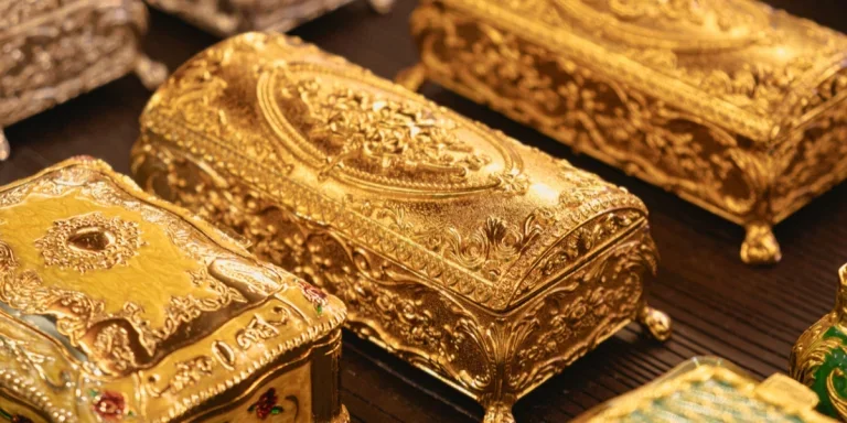 Ornate gold jewelry boxes with intricate designs