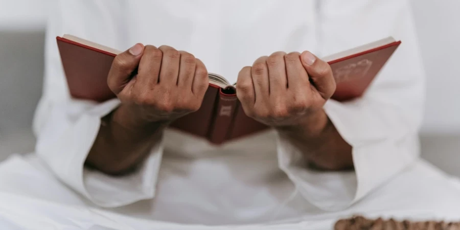 Person Holding a Quran