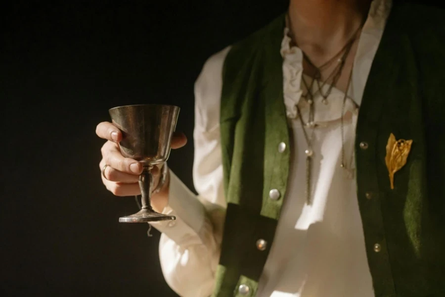 Person Holding a Silver Cup