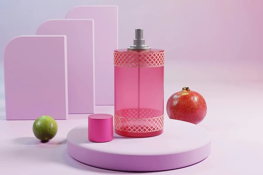Pomegranate and lime beside a pink perfume bottle