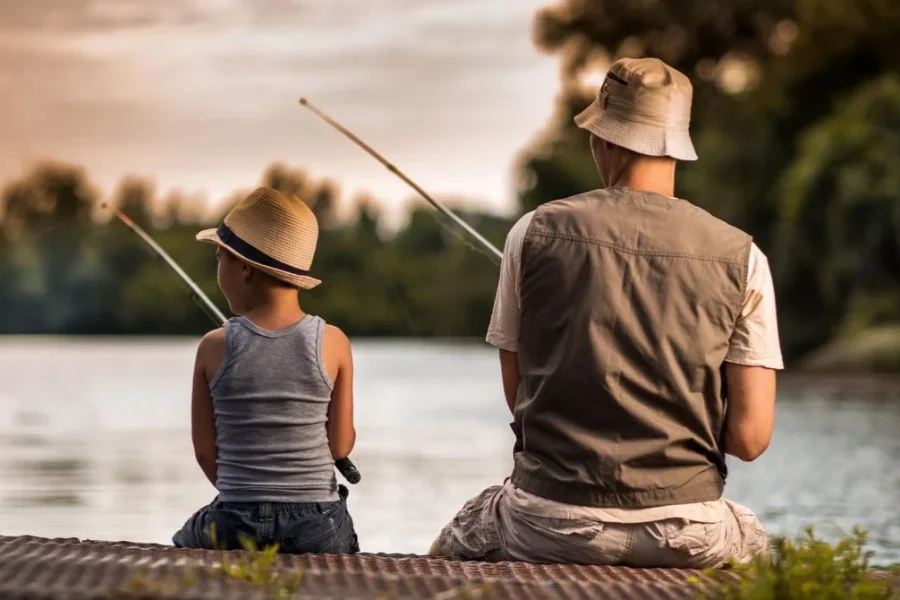 Rear view of a father and son freshwater fishing
