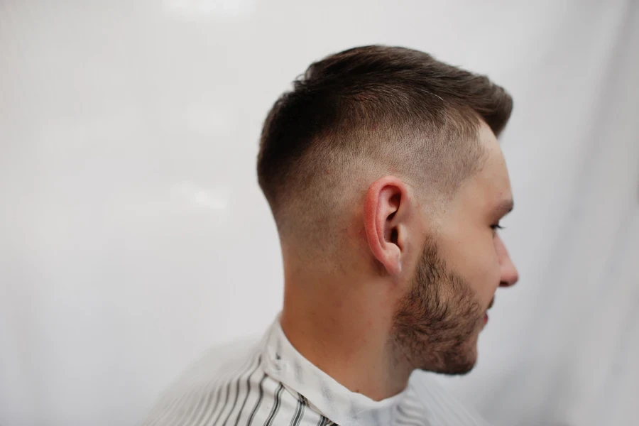 Side profile of man with shorter hair at the back