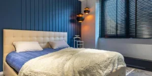 Slightly open blackout blinds in a bedroom