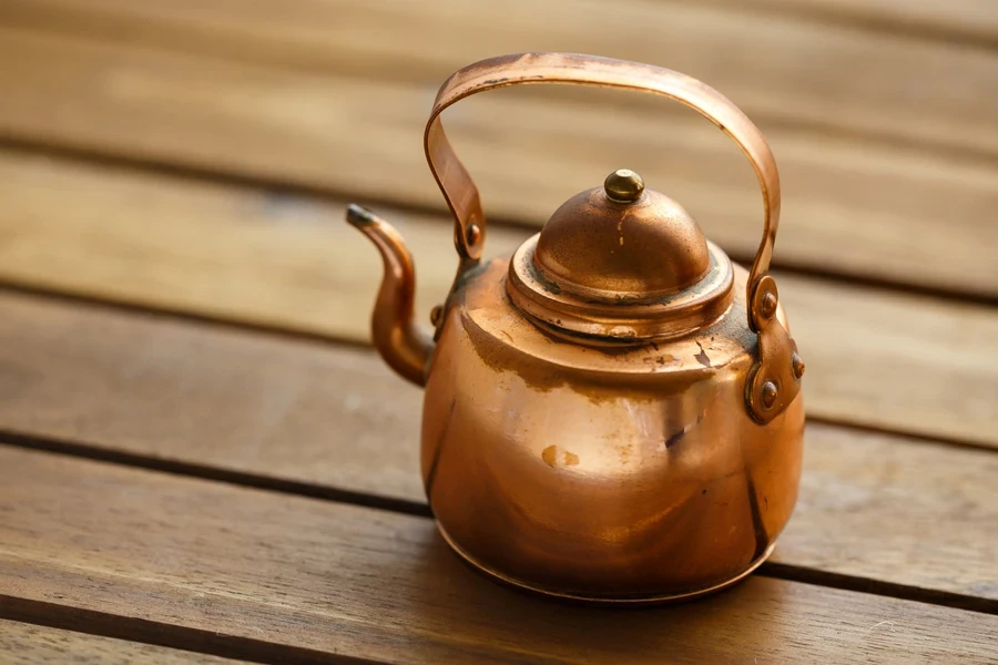 Small diameter copper kettle with copper handle attached