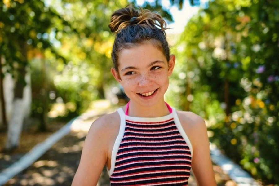 Smiling girl in a messy bun