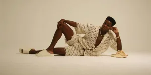 Stylish Male Model in Crochet Outfit Posing Indoors