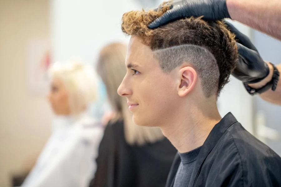 Teenager at barber shop getting textured crop haircut