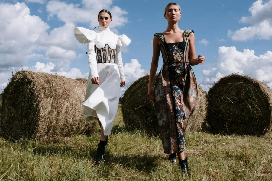 Two Women in Stylish Outfits Standing on Farm