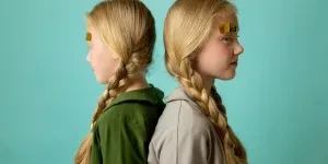 Two girls with long, braided blonde hair
