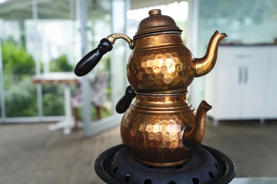 Two small copper kettles stacked on top of each other
