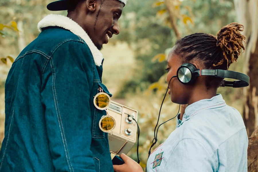 Woman Wearing Headphones Standing Beside Man
