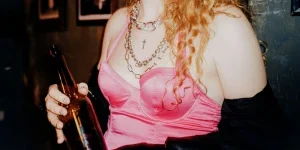 Woman in Pink Brassiere Holding a Beer Bottle