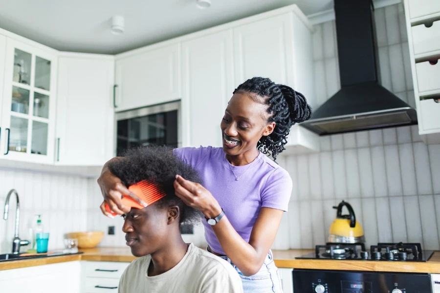 Woman preparing to loc her son’s hair