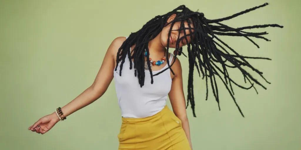 Woman waving her long sisterlocks