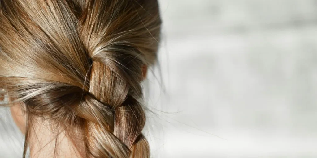 Woman wearing single French braid on sunny day