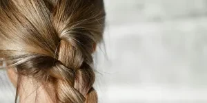 Woman wearing single French braid on sunny day
