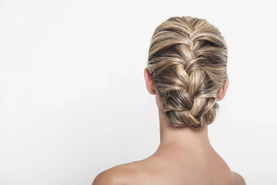 Woman with blond hair wearing a French braid updo
