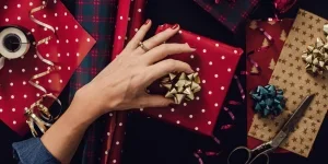 Woman wrapping Christmas presents provided photo shot from above overhead