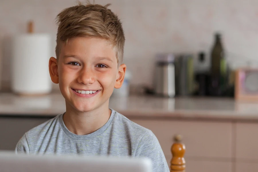 Young boy at home with high fade haircut