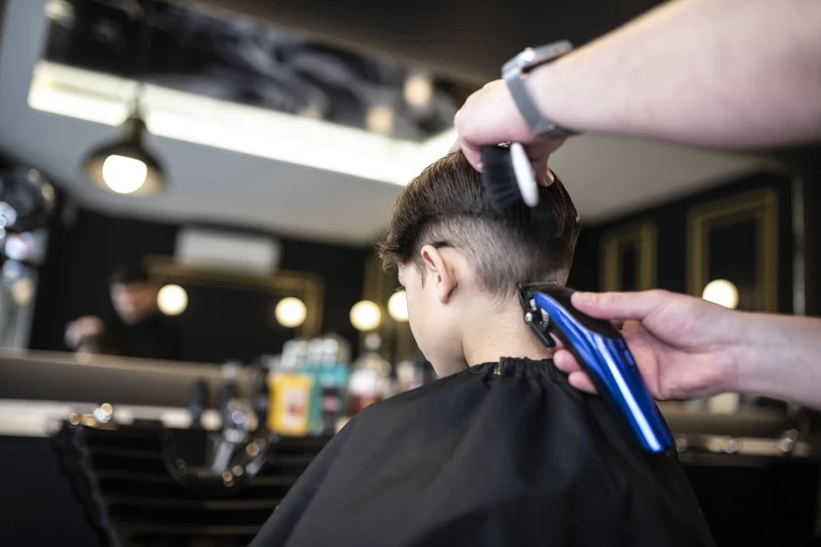 Young boy getting finishing touches down on haircut