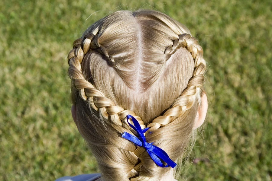 Young girl with blond hair and heart-shaped French braid