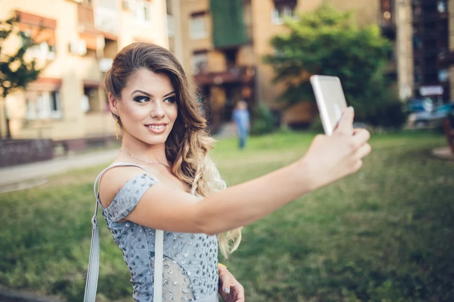 Young girl with long hair taking a selfie
