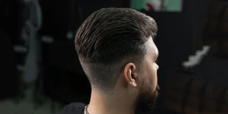 Young man getting new haircut at barber shop