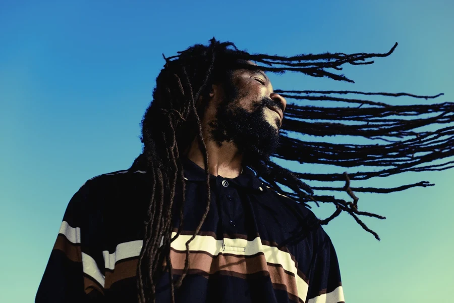 Young man waving his invisible locs