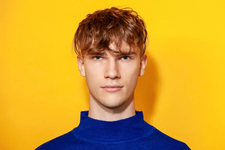 Young man with tousled fringe and ginger hair