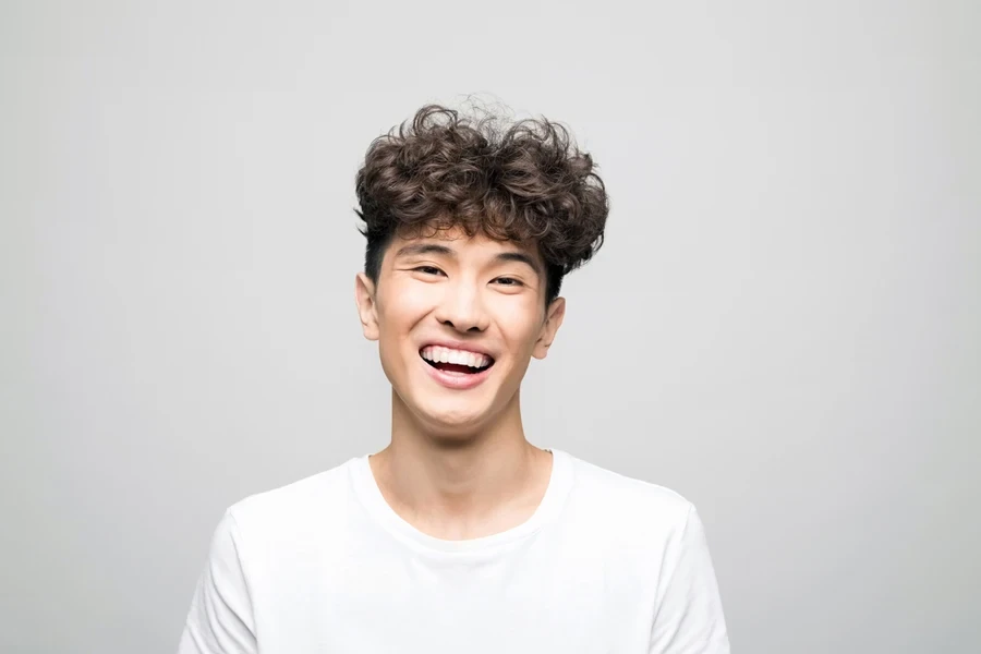 Young man with white t-shirt and quiff mid drop fade