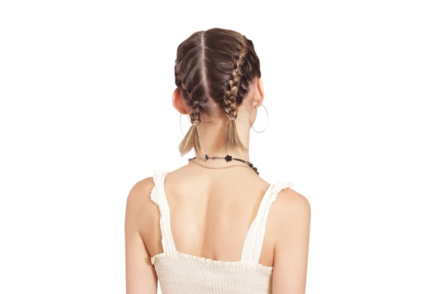 Young woman with two very short French braids