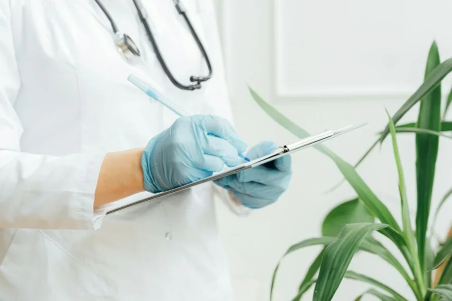 A Person Writing on a Clipboard
