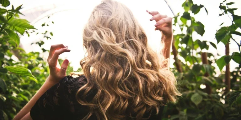 A blond woman with fluffy wavy hair.