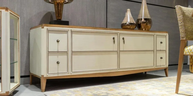 A cabinet with drawers and decorative pieces on top