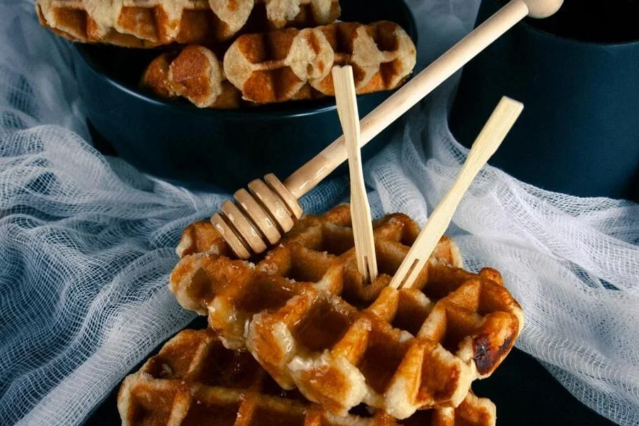 A close-up of waffles with honey