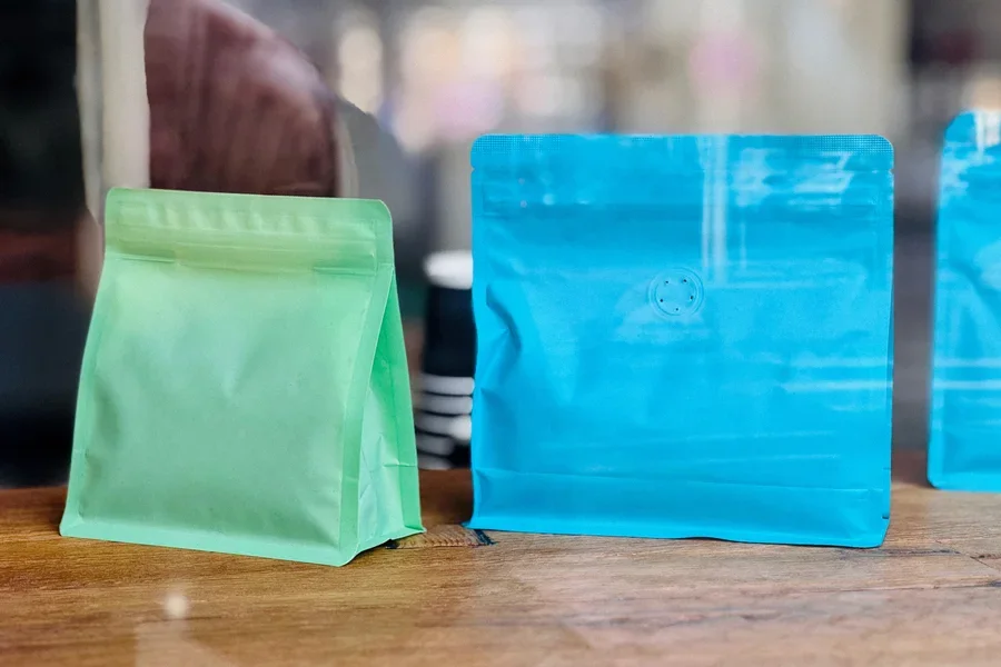 A combination of green and blue stand-up coffee pouches displayed for specialty coffee packaging mock ups.