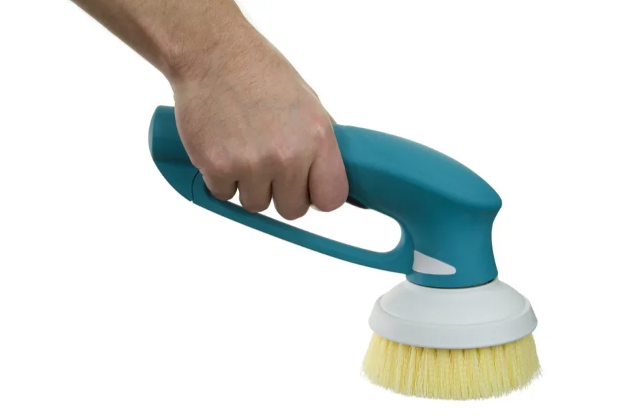 A cordless scrubber being used to scrub tiles