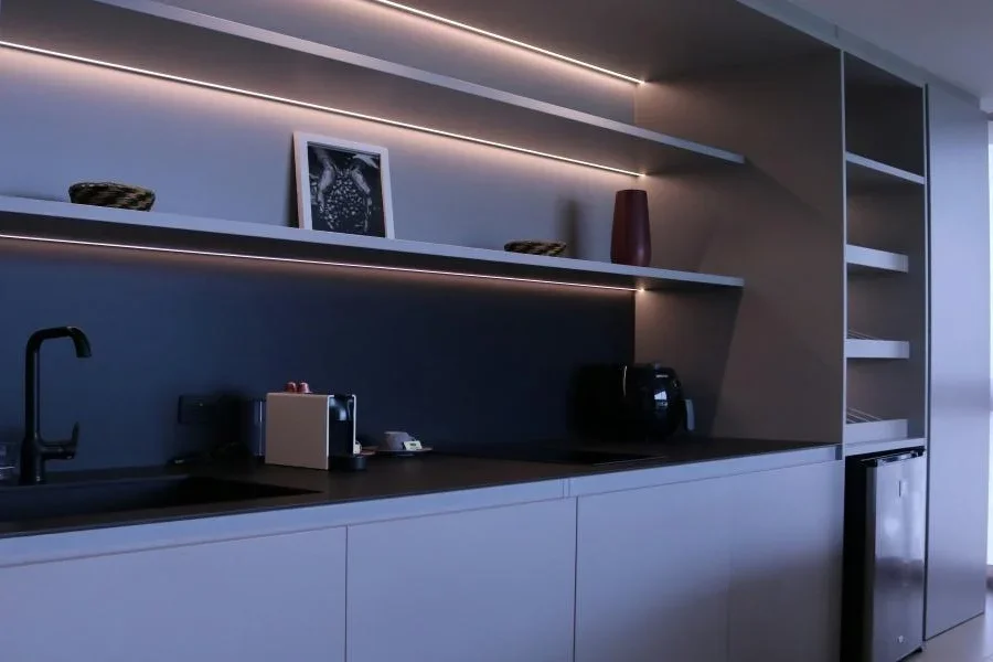 A kitchen with LED light bar under cabinet lighting