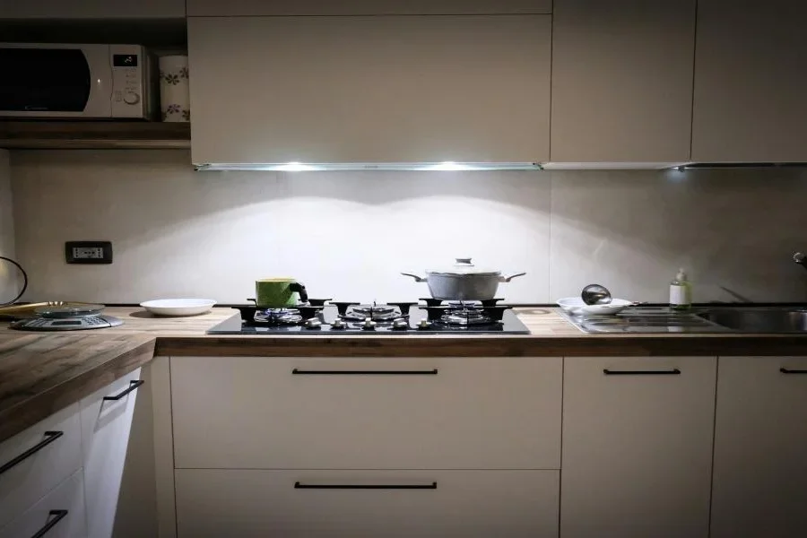 A kitchen with puck light under cabinet lighting