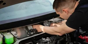 Un homme répare une voiture