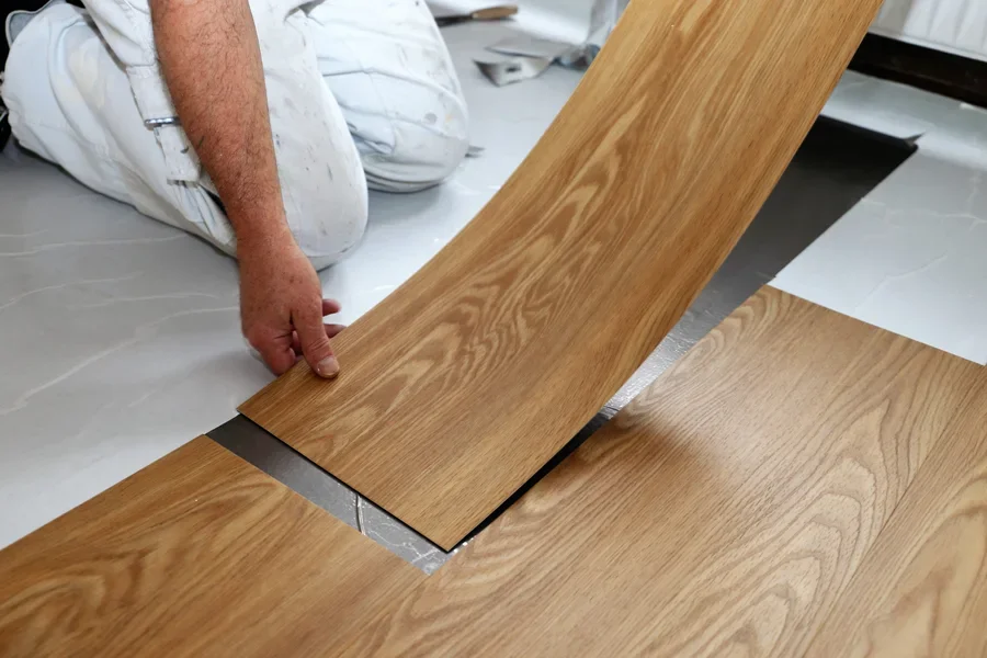 A man installing PVC interior flooring