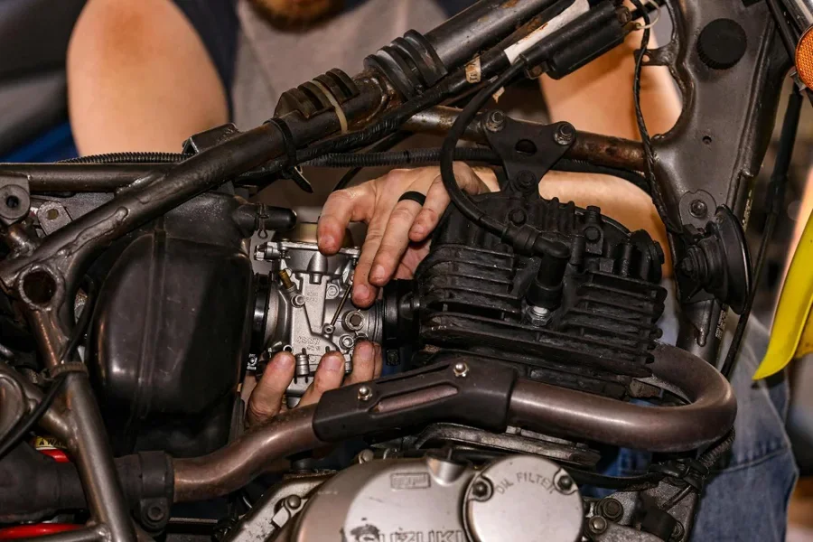 A person holding a motorcycle