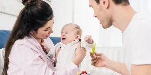 A photo of new parents with their newborn