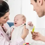 A photo of new parents with their newborn