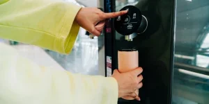 A stainless steel water dispenser in use