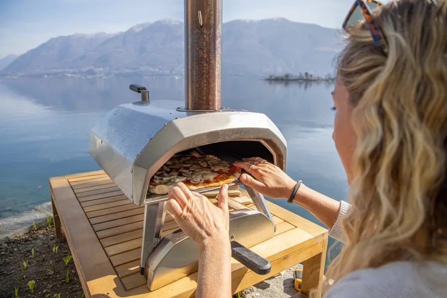 A tabletop pizza oven in use