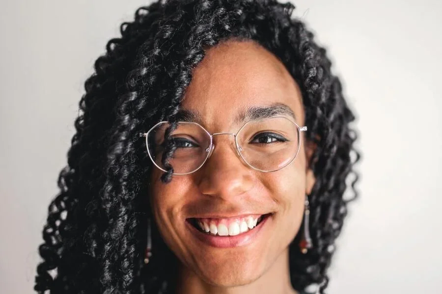 A woman in glasses and long curly hair