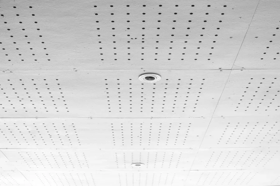 An installed white acoustic ceiling panel