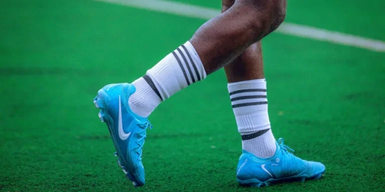 Close-up of Soccer Player's Feet on Green Field