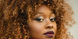 Closeup image of a woman with 3c curly brown hair